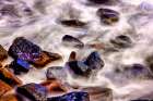 Lava beach rocks worn by centuries of sea water cover the black sand beaches of Bali Art Print